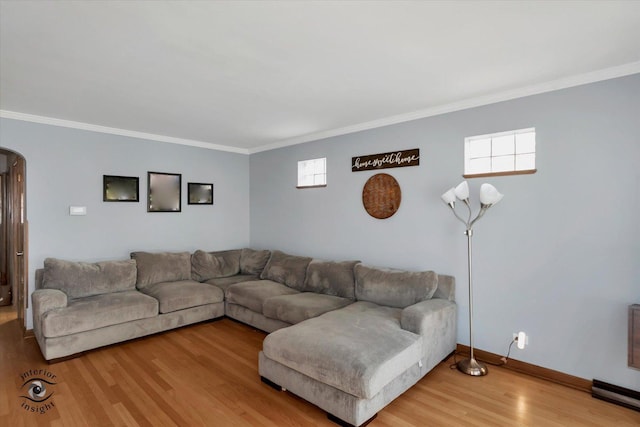 living room featuring wood-type flooring and ornamental molding