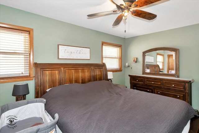 bedroom featuring multiple windows and ceiling fan