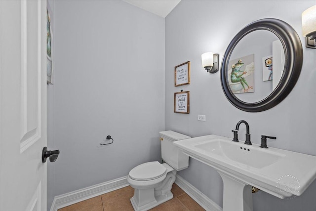 bathroom featuring sink, tile patterned floors, and toilet