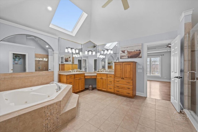 bathroom featuring tile patterned flooring, plus walk in shower, vanity, ceiling fan, and lofted ceiling with skylight