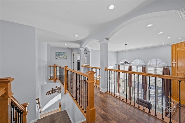 hallway with decorative columns and dark hardwood / wood-style flooring