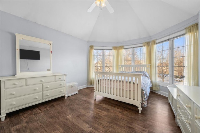 bedroom featuring lofted ceiling, dark hardwood / wood-style flooring, multiple windows, and ceiling fan