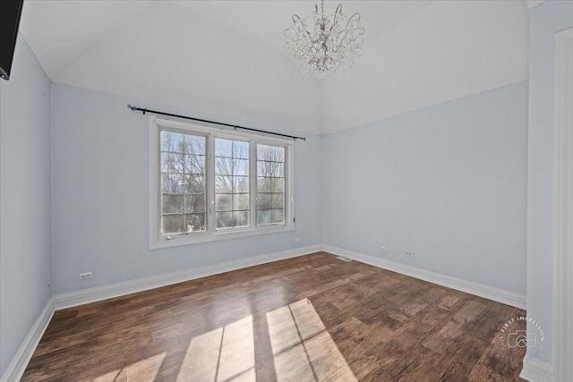 unfurnished room with a notable chandelier, vaulted ceiling, and wood-type flooring