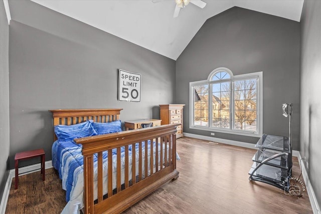 bedroom with hardwood / wood-style flooring, ceiling fan, and vaulted ceiling