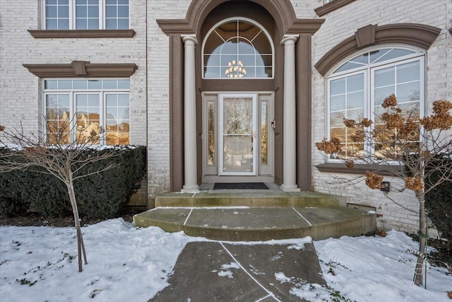 view of snow covered property entrance