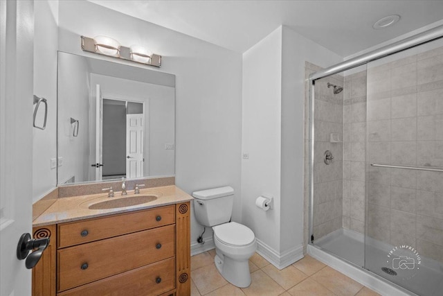 bathroom with toilet, vanity, tile patterned floors, and a shower with shower door