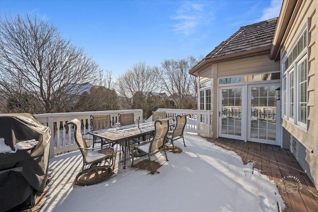 snow covered deck featuring area for grilling