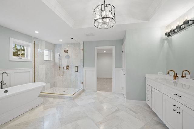 bathroom with an inviting chandelier, crown molding, plus walk in shower, and a tray ceiling