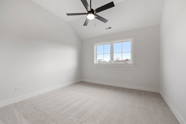 spare room featuring carpet flooring, ceiling fan, and lofted ceiling