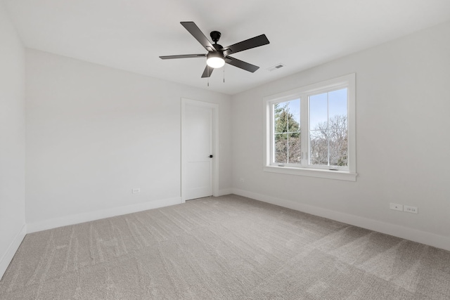 unfurnished room with ceiling fan and carpet floors