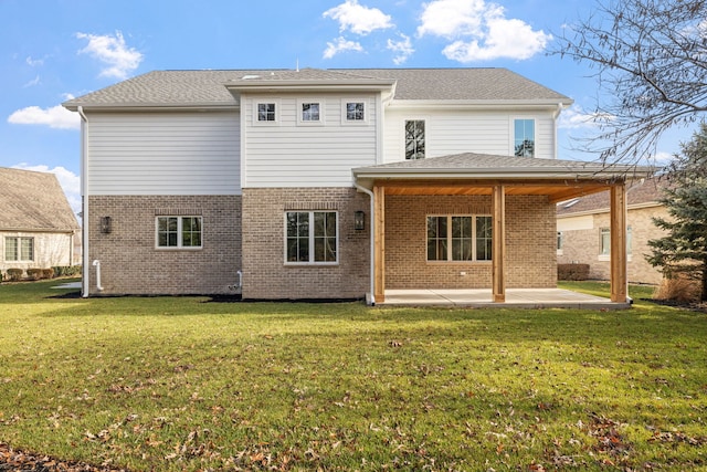 back of house featuring a patio area and a yard