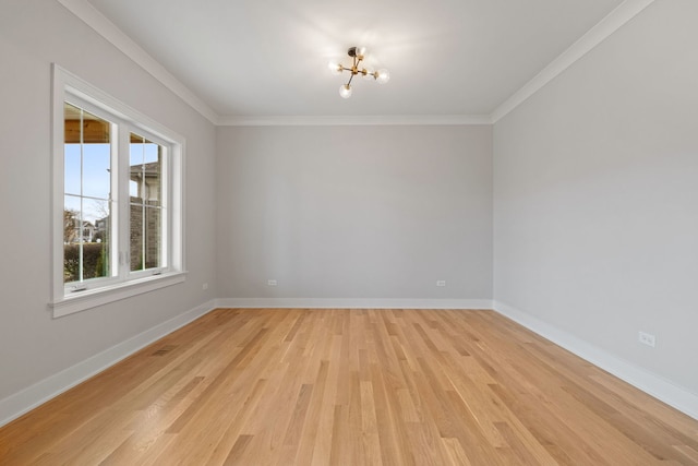 unfurnished room with light hardwood / wood-style flooring, crown molding, and a notable chandelier