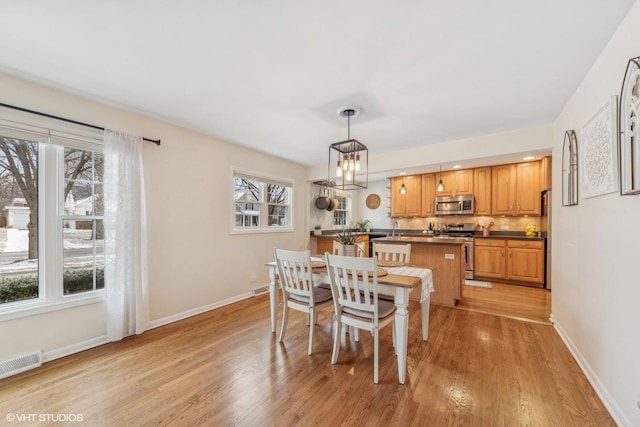 dining area with light hardwood / wood-style floors