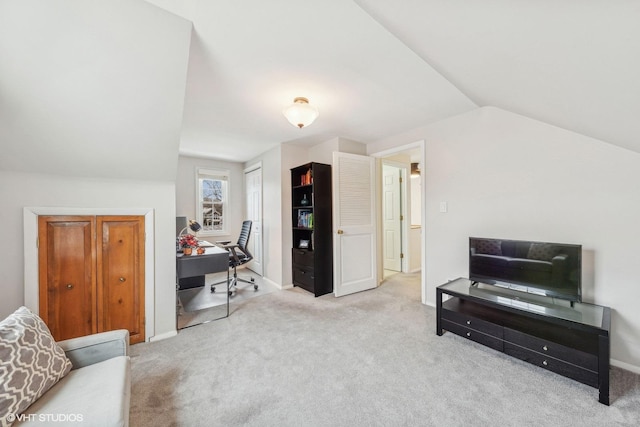 office space featuring vaulted ceiling and light carpet