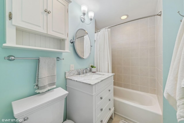 full bathroom with vanity, shower / tub combo, and toilet