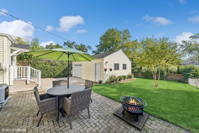 view of patio featuring an outbuilding, an outdoor fire pit, and central air condition unit