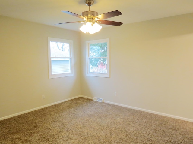 carpeted empty room featuring ceiling fan