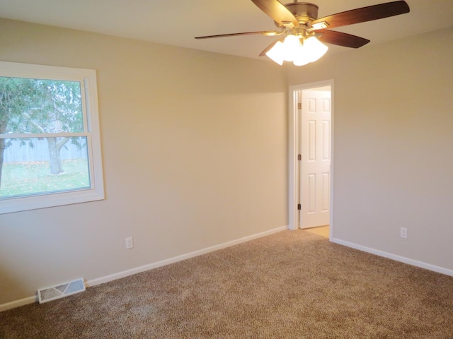 spare room featuring carpet and ceiling fan