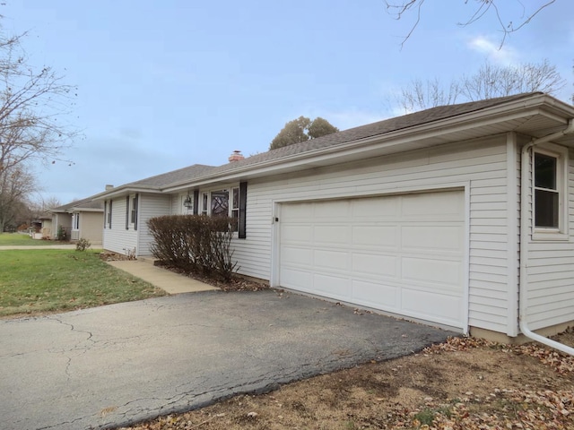 single story home with a front yard and a garage