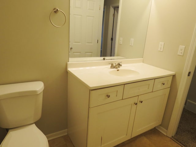 bathroom featuring tile patterned floors, vanity, and toilet