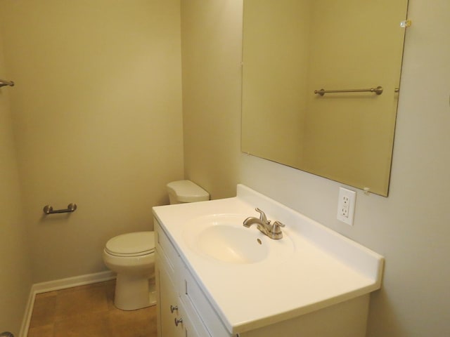 bathroom featuring tile patterned floors, vanity, and toilet