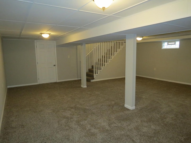 basement featuring dark carpet