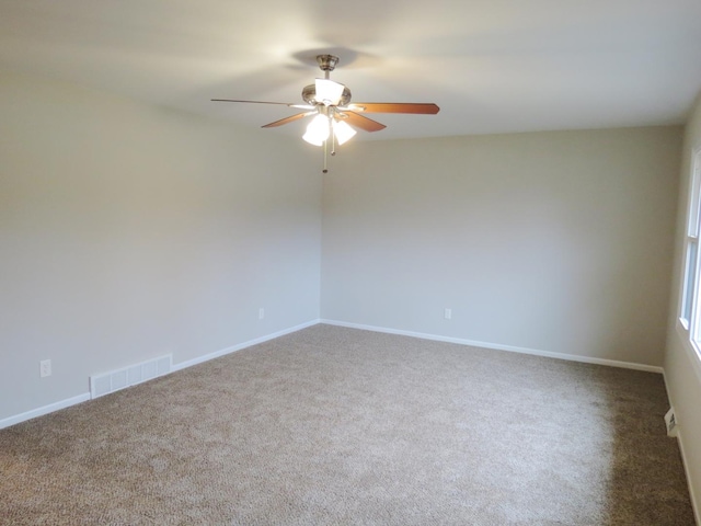 spare room with carpet and ceiling fan