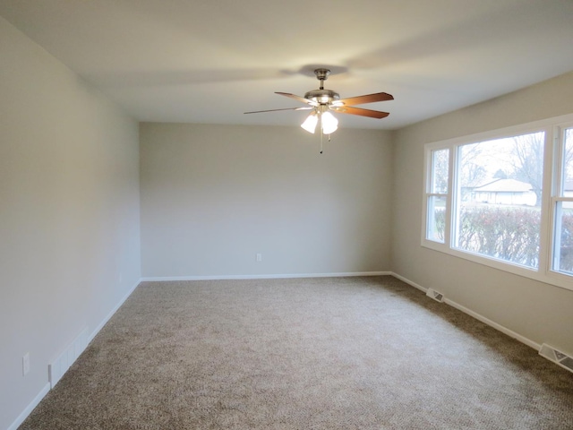 carpeted empty room featuring ceiling fan