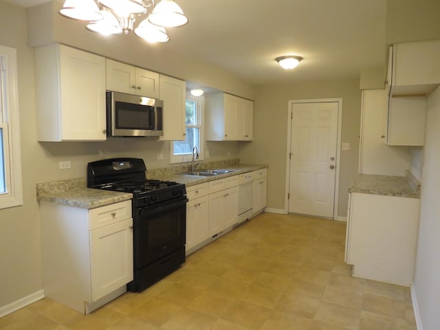 kitchen with dishwasher, sink, black range with gas stovetop, a chandelier, and white cabinets