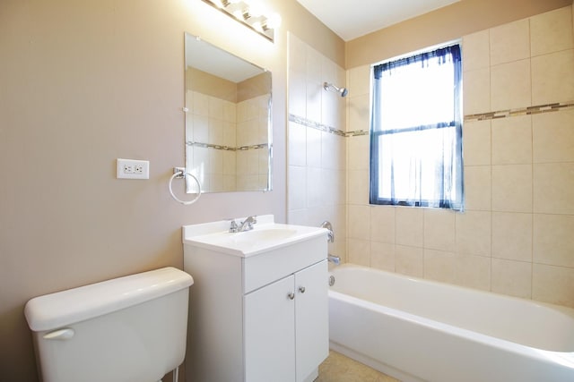 full bathroom featuring tiled shower / bath, tile patterned flooring, vanity, and toilet