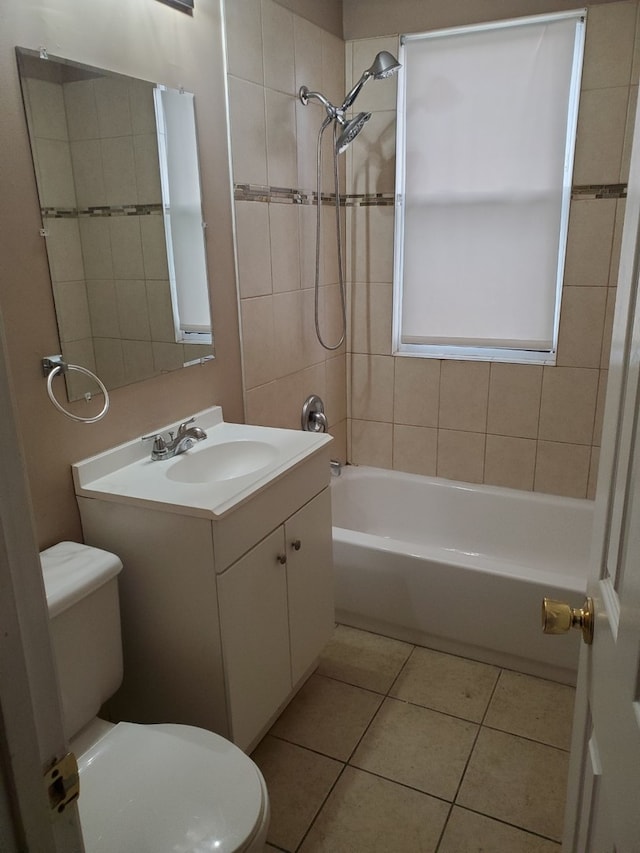 full bathroom with toilet, vanity, tile patterned floors, and tiled shower / bath