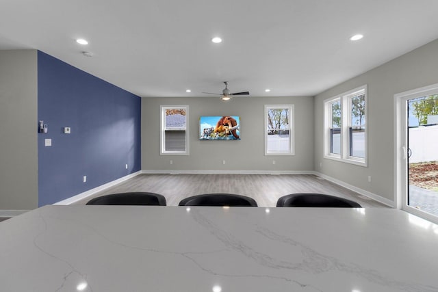 interior space with ceiling fan, a healthy amount of sunlight, and light hardwood / wood-style floors