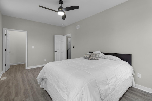 bedroom with ceiling fan and wood-type flooring