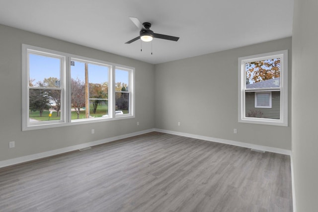 empty room featuring ceiling fan and light hardwood / wood-style floors