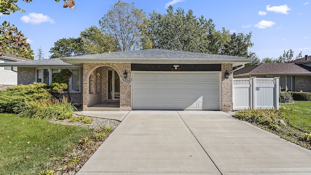 view of front of home featuring a front yard and a garage