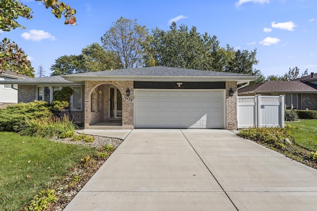 single story home featuring a front yard and a garage