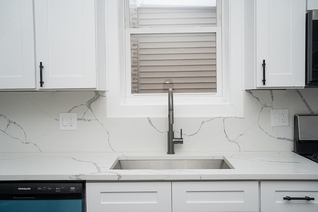 kitchen with dishwasher, sink, light stone countertops, tasteful backsplash, and white cabinetry