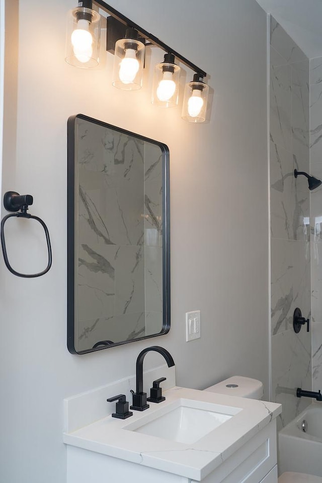 full bathroom featuring vanity, toilet, and tiled shower / bath combo