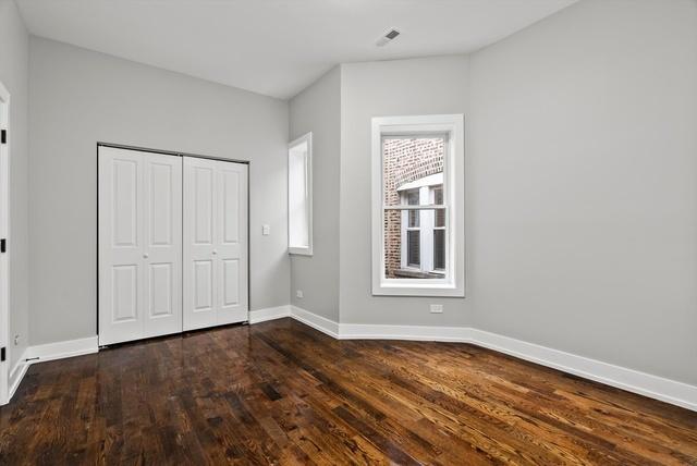 unfurnished bedroom featuring dark hardwood / wood-style flooring and a closet