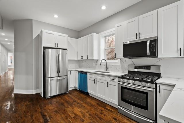 kitchen featuring white cabinets, dark hardwood / wood-style flooring, sink, and stainless steel appliances