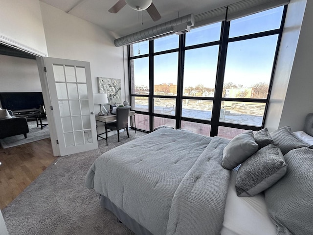 bedroom featuring hardwood / wood-style floors, ceiling fan, and floor to ceiling windows