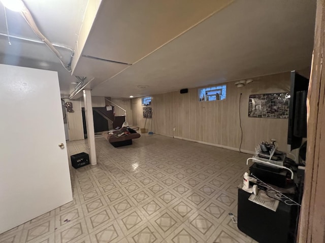 basement featuring wooden walls