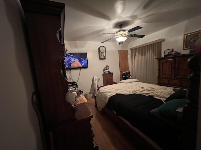 bedroom with ceiling fan and dark wood-type flooring