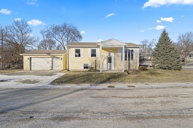 view of front of house with a front yard and a garage