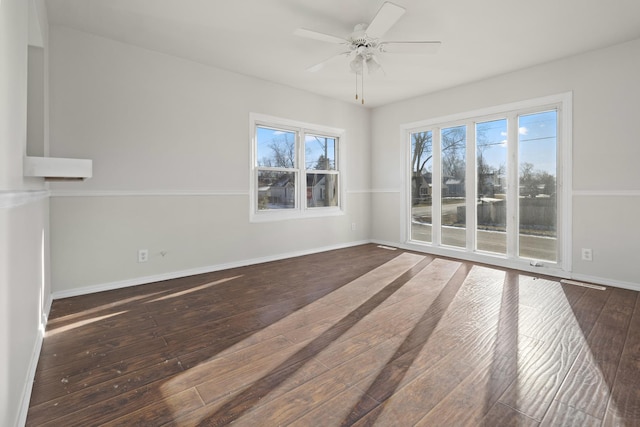 spare room featuring ceiling fan and dark hardwood / wood-style floors