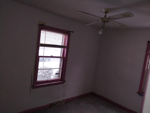 unfurnished room featuring ceiling fan and concrete flooring