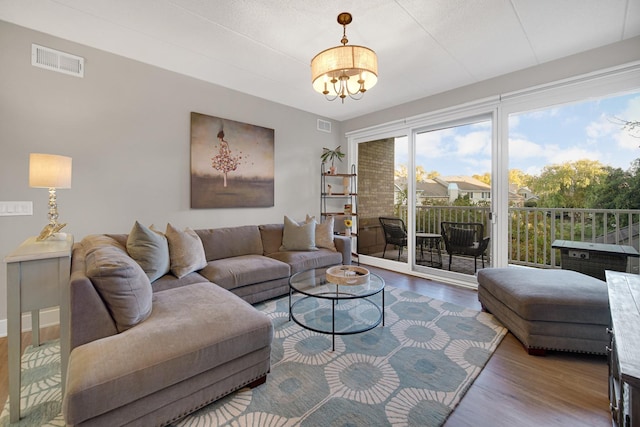 living room featuring a notable chandelier and hardwood / wood-style flooring