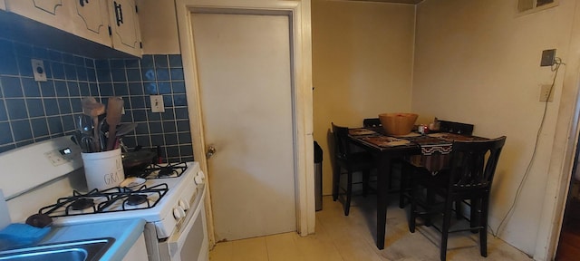 kitchen featuring white range with gas stovetop