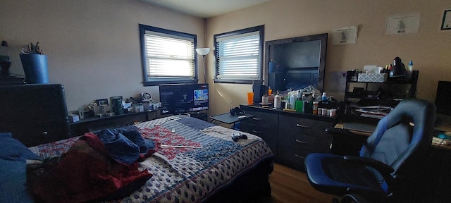 bedroom with hardwood / wood-style flooring