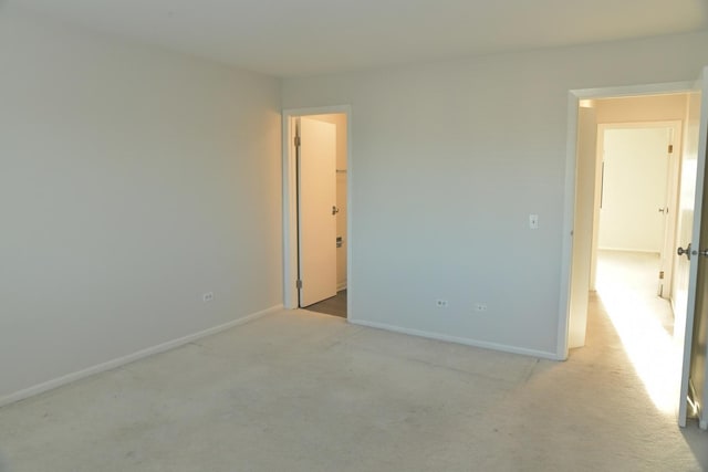 unfurnished room with light colored carpet